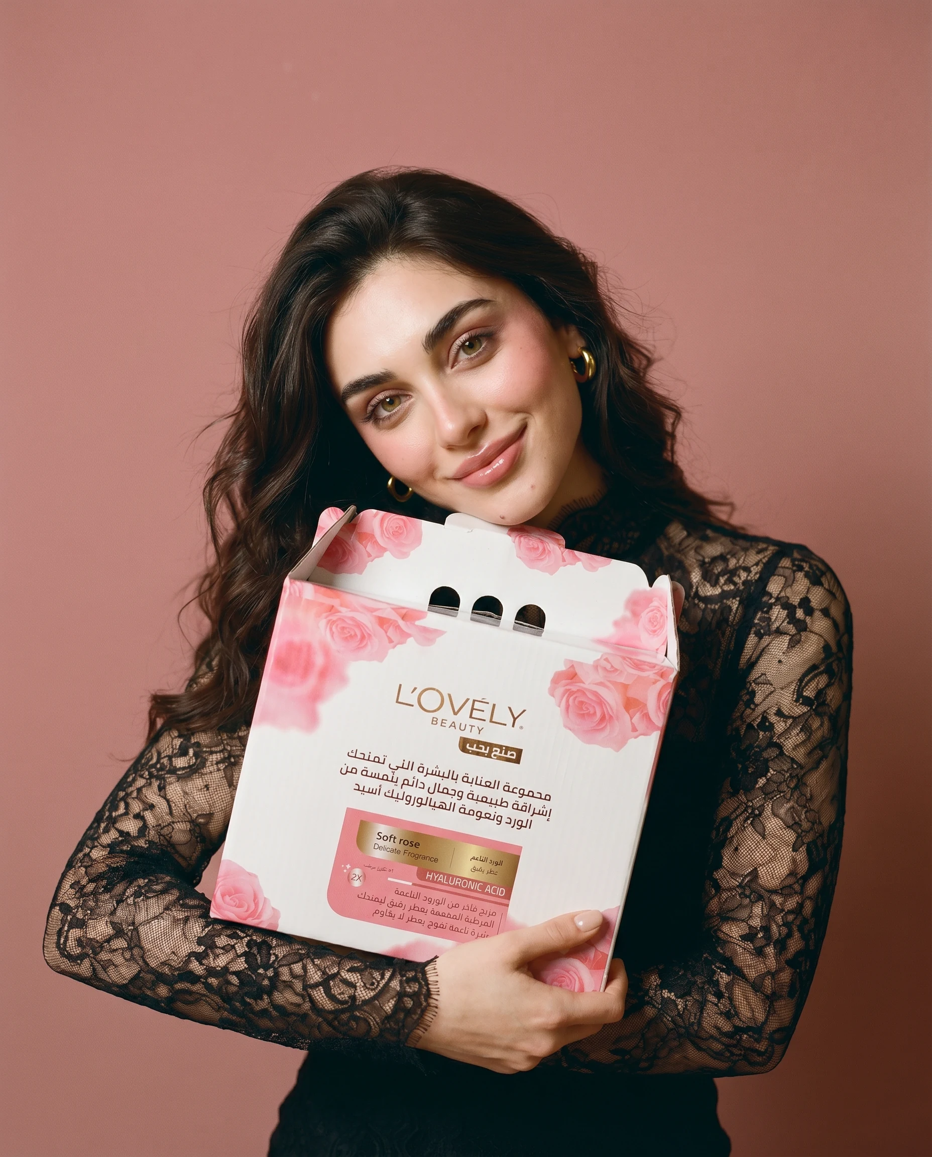 The campaign model holding the hyaluronic collection box — the editorial campaign cover